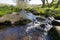 Burbage brook becomes a blur flowing over gritstone rocks