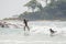 Bureh Beach, Sierra Leone - January 11, 2014: Two unidentified young African boys surfing at only surf spot in country
