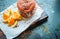 Burger with beef on a wooden Board on rusty steel background