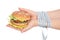 Burger cheeseburger in hands with measure tape