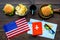 Burger, chips, map, tickets and usa flag for gastronomical tourism to America on wooden background top view