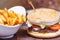 Burger close up with fresh tomato, cheese, meat and french fries