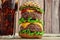 Burger and cola with ice on a wooden background