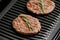 Burger cutlets are fried on a smart electric grill, homemade burgers