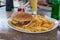 Burger and french fries on the table. Delicious food fast food. American food in a cafe