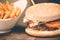 Burger with fresh tomato, cheese, meat and french fries. Selective focus