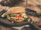 Burger with grilled prawns close up on wooden board