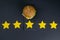 Burger isolated on a black background with a rating of 5 stars. Yellow stars