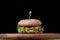 Burger with a latch on a wooden board on a black background