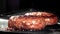 A burger made from natural meat is fried in a frying pan. Filmed on a high-speed camera at 1000 fps.