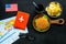 Burger, map, tickets, passport and usa flag for gastronomical tourism to America on black background top view