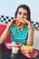 This burger is perfect. Cropped portrait of an attractive young woman enjoying a burger in a retro diner.