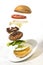 Burger preparation sliced  ingredients levitating on white background