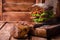 Burger sandwich with lettuce, roasted bacon on dark wood cutting board. Selective focus