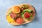 Burgers on a wooden board. Homemade hamburger recipe. Bbq grilled beef patties