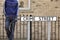 Burglar standing on street with crowbar