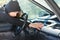 Burglar thief breaking into car stealing smartphone