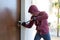 Burglar trying to force a door lock