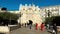 Burgos, Spain - October 18, 2022. Tourists walking through the arch of Santa Maria and medieval bridge in Burgos, Spain