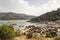 Burguillo reservoir in summer. Beach and mountains.