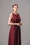 Burgundy chic gown. Red cocktail sleeveless dress with rounded neckline