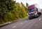 Burgundy modern semi truck and reefer trailer in straight wide h