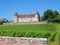 Burgundy - Scenic view of remote luxury Chateau de Rully surrounded by stunning vineyard in Burgundy, France.