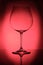 Burgundy wine glass in red back lit
