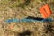 BURIED CABLE flag sign on steel rod and colored cable location marking on green grass clearly designates underground utility lines