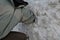 Buried man under an avalanche of snow looking with his hand where his friend is. watching hands from a pile is a bunker, igloo, or