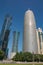 Burj Doha (Burj Qatar, Doha Tower), QIPCO Tower and Palm Tower against clear blue sky, close up view