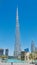 Burj Khalifa world`s tallest tower against a deep blue sky background in Dubai, United Arab Emirates with reflective pond in front