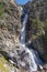 Burkhan bulak waterfall, the highest waterfall in Kazakhstan. Waterfall with strong stream is flowing among rocky mountains. Outdo