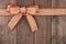 Burlap Christmas bow and ribbon top border on wood