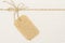 Burlap Cloth Label Tag and Tied Rope Bow over Cardboard Paper
