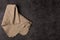 Burlap napkin on a dark structural background, top view