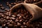 Burlap sack of coffee beans against dark wood background with whole coffee beans spilling out over wood panel