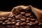 Burlap sack of coffee beans against dark wood background with whole coffee beans spilling out over wood panel