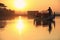 Burmese boatman and buddhist novice sitting in boat