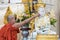 Burmese buddhist monk pouring water over the Buddha statue for blessing in Shwedagon pagoda in Yangon, Myanmar