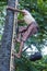 Burmese farmer climbing a Palm tree