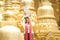 Burmese female are going to make merit at the temple. Young female with traditional burmese holding bowl of rice on head