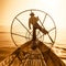 Burmese fisherman on bamboo boat catching fish. Inle lake, Myanmar (Burma)