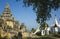 Burmese heritage architecture. Yellow moldy walls of Maha Aungmye Bonzan Monastery and white and golden pagodas