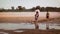 Burmese local woman crossing the Irrawaddy river. Village youth playing football