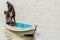 Burmese man handling homemade motor boat in river 1