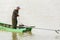 Burmese man starting the engine of homemade motor boat 1