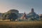 Burmese Peasant Working in Field near Ancient Temples in the Morning, Bagan, Myanmar