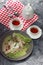 Burmese Tea Leaf Salad with vegetables, chicken and eggs with a delicious sprinkling of spices and warm tea with a red napkin mat