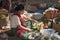 Burmese woman cut vegetables on asian open market